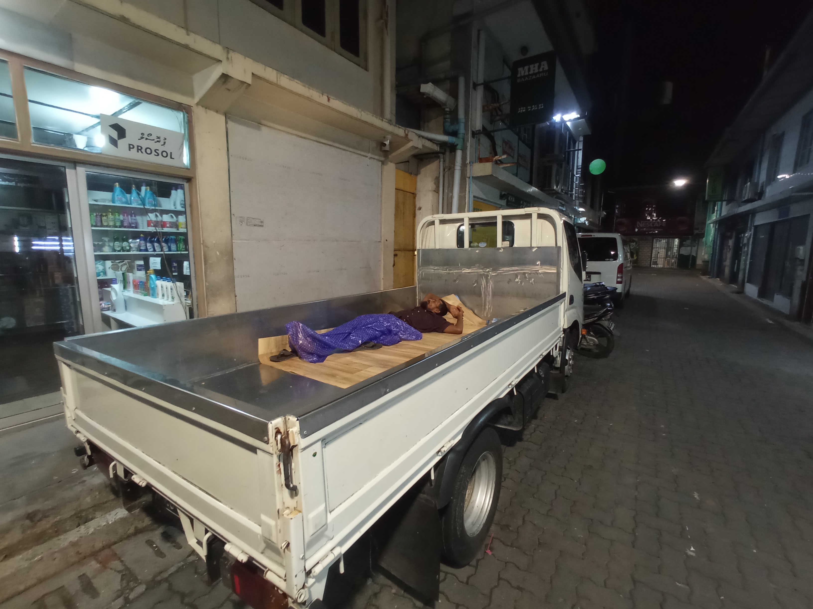Young man sleeping inside a truck